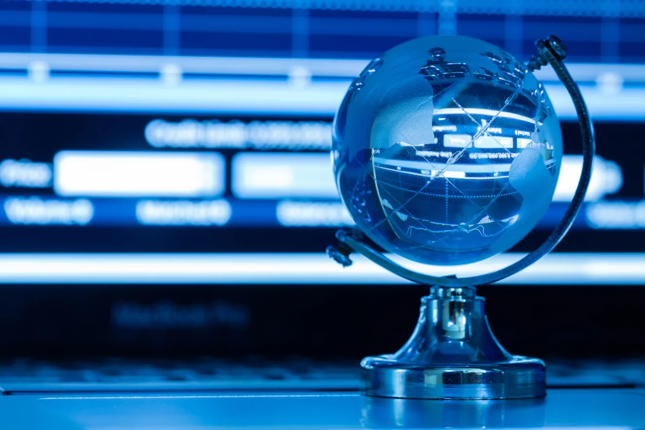 The business concept of the glass world on a laptop keyboard